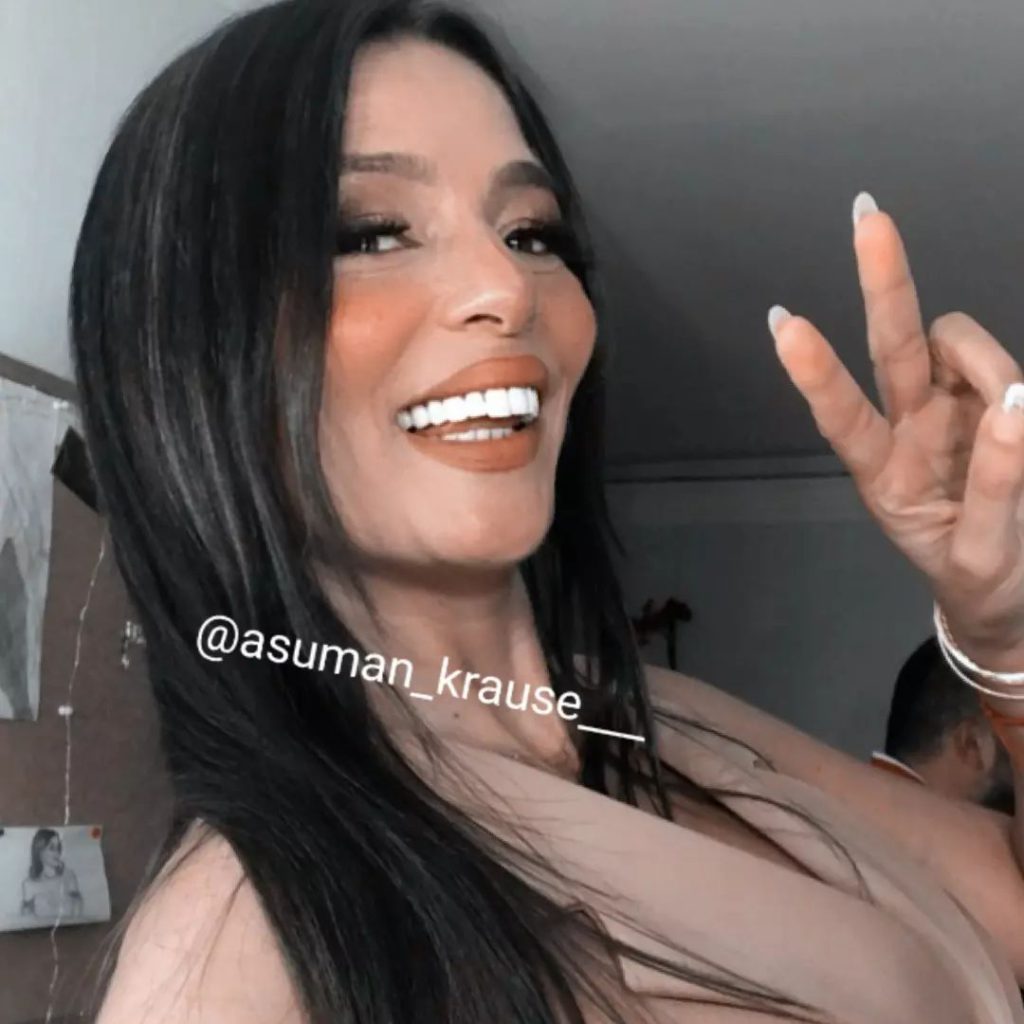 Asuman Krause smiles naked