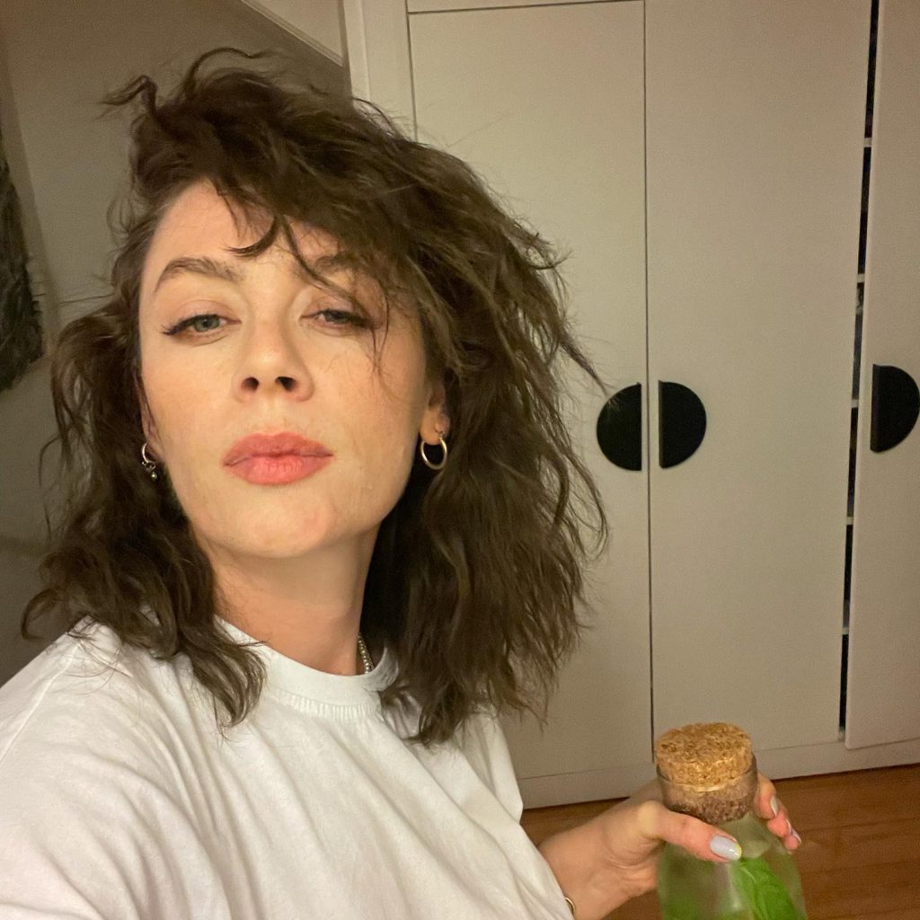 Demet Evgar smiles hot bikini