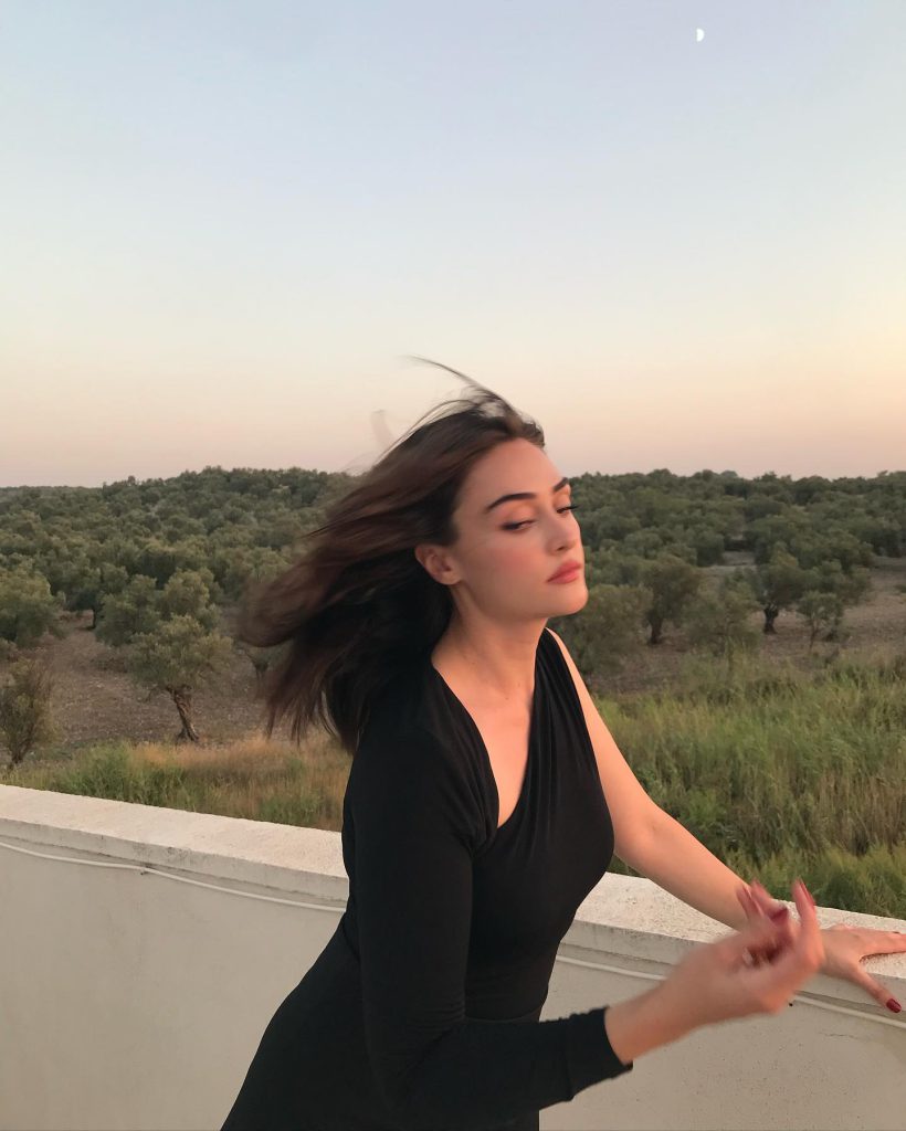 Esra Bilgiç smiles naked
